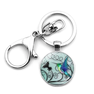 Macro detail of hummingbird glass pendant with silver alloy lobster clasp and keyring