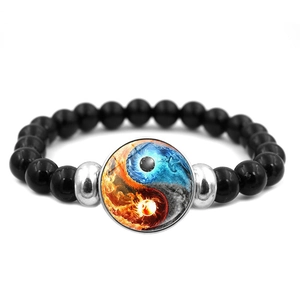 Detailed view of Yin Yang beaded bracelet with black beads and blue-orange fire ice glass charm