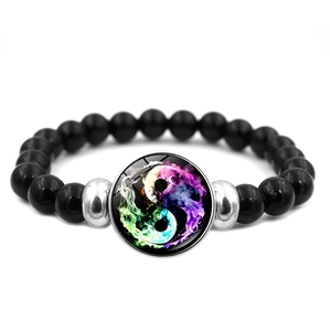 Detail of beaded bracelet featuring a colorful smoke Yin Yang glass charm and black beads