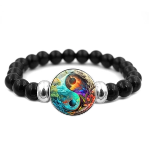 Detailed macro shot of Yin Yang beaded bracelet with colorful nature motif and silver spacers