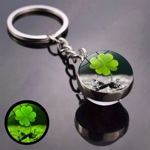 Luminous four-leaf clover keychain with double-sided glass ball and green glow effect