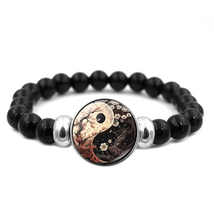 Black beaded elastic bracelet featuring a Yin Yang Tai Chi glass cabochon pendant