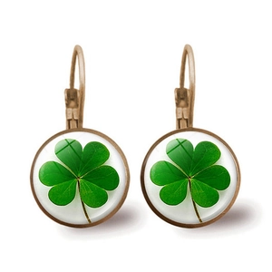 Detailed view of bronze lever-back earrings with green lucky clover glass domes