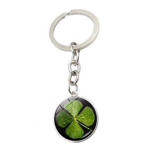 Detail view of silver clover keychain with green four-leaf clover crystal glass pendant