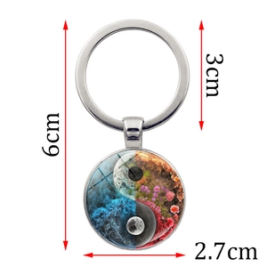 Yin Yang artistic glass dome keychain with blue waves and floral patterns 2.7cm pendant