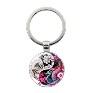 Yin Yang Tai Chi glass keychain with white and blue dragon art and pink cherry blossoms