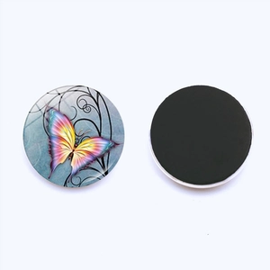 Detail of round 25mm glass butterfly magnet showing both colorful front and black magnetic back