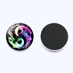 Detail of Yin Yang Tai Chi glass fridge magnet with colorful nebula pattern and magnetic back