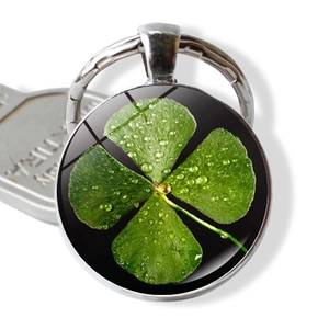 Lucky four leaf clover keychain with green glass cabochon pendant on polished silver ring