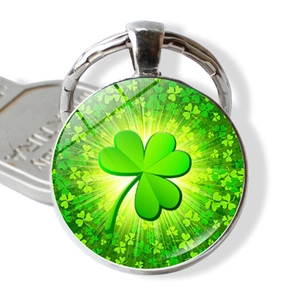 Detailed view of lucky four-leaf clover glass gem pendant on silver metal keychain