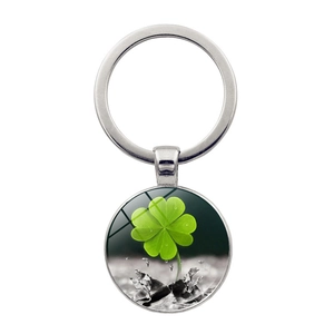 Four-leaf clover lucky charm keychain with silver metal ring and glass dome pendant