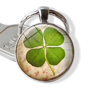 Four-leaf clover time gem keychain with silver alloy frame and vintage floral background