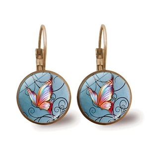 Detail of vintage leverback earrings with colorful butterfly glass cabochon in bronze