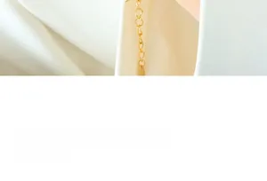 Detail of a minimalist gold-plated link chain with an elegant polished finish