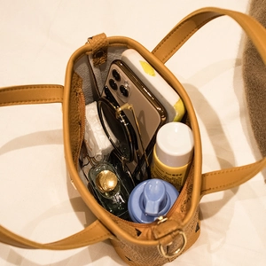 Classic brown bucket bag with monogram print showing spacious interior with daily essentials