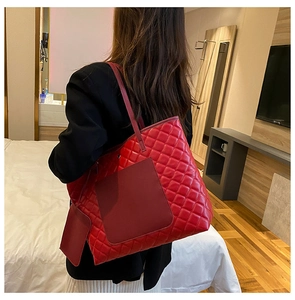 Rear view of a red quilted tote bag with matching mini pouch and front smooth pocket