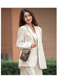 Outdoor street style shot of a woman wearing a brown checkerboard pattern mini chain bag