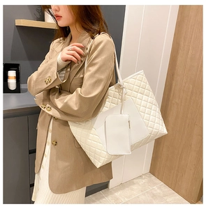 Detail of white quilted tote bag with matching pouch and slim shoulder straps