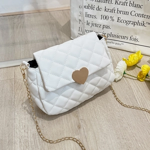 Close-up of white quilted mini bag with golden heart buckle and fine chain strap