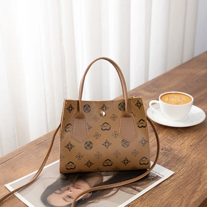 Brown vintage printed tote bag with heart patterns on a wooden table with coffee