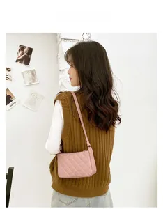 Detailed back view of pink quilted faux leather underarm bag on model in a soft aesthetic