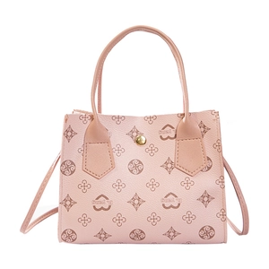 Close-up of pink litchi grain leather handbag featuring heart patterns and metal buckle