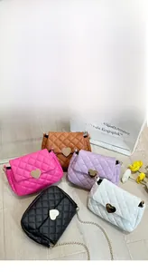 Detailed close-up showing five quilted chain bags with heart-shaped gold locks in various colors