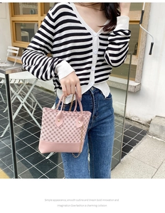 Detailed view of pink hobo bag with vintage monogram pattern and gold chain strap