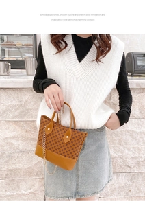 Detail of vintage brown monogram hobo bag with gold chain and leather patchwork
