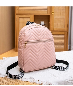 Detail of pink faux leather mini backpack featuring V-shaped quilting and logo webbing straps