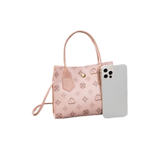 Pink floral printed handbag with heart patterns, top handle, and strap on white background