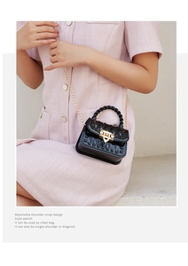 Close-up of black jelly mini bag with gold pyramid studs and metallic chain strap