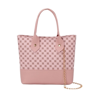 Pink patchwork tote bag with clover print pattern and golden chain strap detail