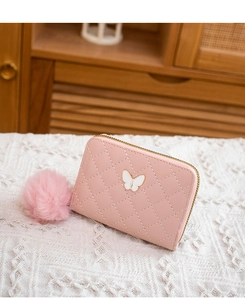 Pink quilted leather wallet with butterfly ornament and fuzzy pom pom detail