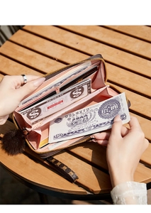 Internal view of long leather wallet with multi-card slots and a pink lining