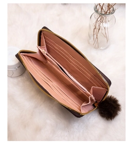 Detailed view of women's long wallet featuring multi-card slots and pink lining interior