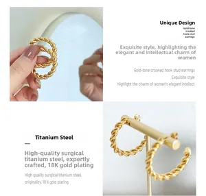 Close-up of twisted rope-style earrings made of 18K gold plated surgical titanium steel