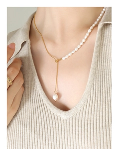 Detail of freshwater pearl and 18K gold-plated snake chain Y-shaped necklace on model