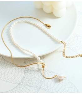 Detail of adjustable gold snake chain necklace with baroque freshwater pearls and clasp