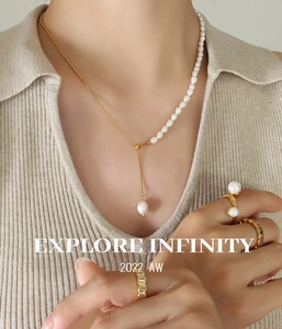 Detail of 18K gold plated snake chain with freshwater pearls and matching gold rings