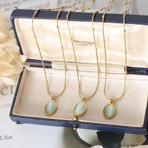 Collier vintage en acier inoxydable doré 18k avec pendentif ovale en pierre œil de chat
