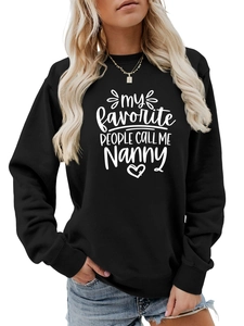 Détail des poignets côtelés et de l'imprimé Nanny sur un sweat noir à col rond