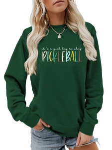 Detail of dark green pickleball sweatshirt featuring ribbed cuffs and white logo print