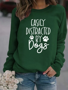Detail of dark green sweatshirt with easily distracted by dogs print and ribbed cuffs