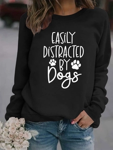 Detail of black crewneck sweatshirt with white Easily Distracted by Dogs print and paw icons