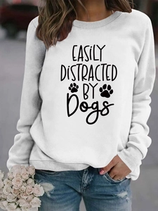 Detail of white sweatshirt featuring easily distracted by dogs print and ribbed cuffs