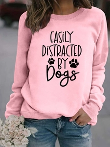 Detail view of pink sweatshirt cuffs and easily distracted by dogs print on soft fabric