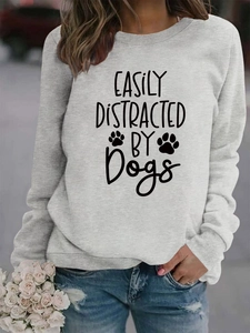 Detail of grey crewneck sweatshirt featuring Easily Distracted by Dogs print and ribbed collar