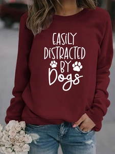 Detail of burgundy pullover sweatshirt with easily distracted by dogs print