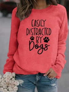 Detail of red crewneck sweatshirt with ribbed cuffs and Easily Distracted By Dogs print